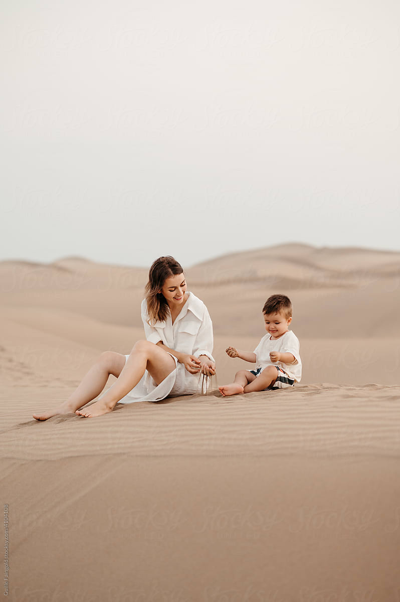 Mom and son playing with sand.