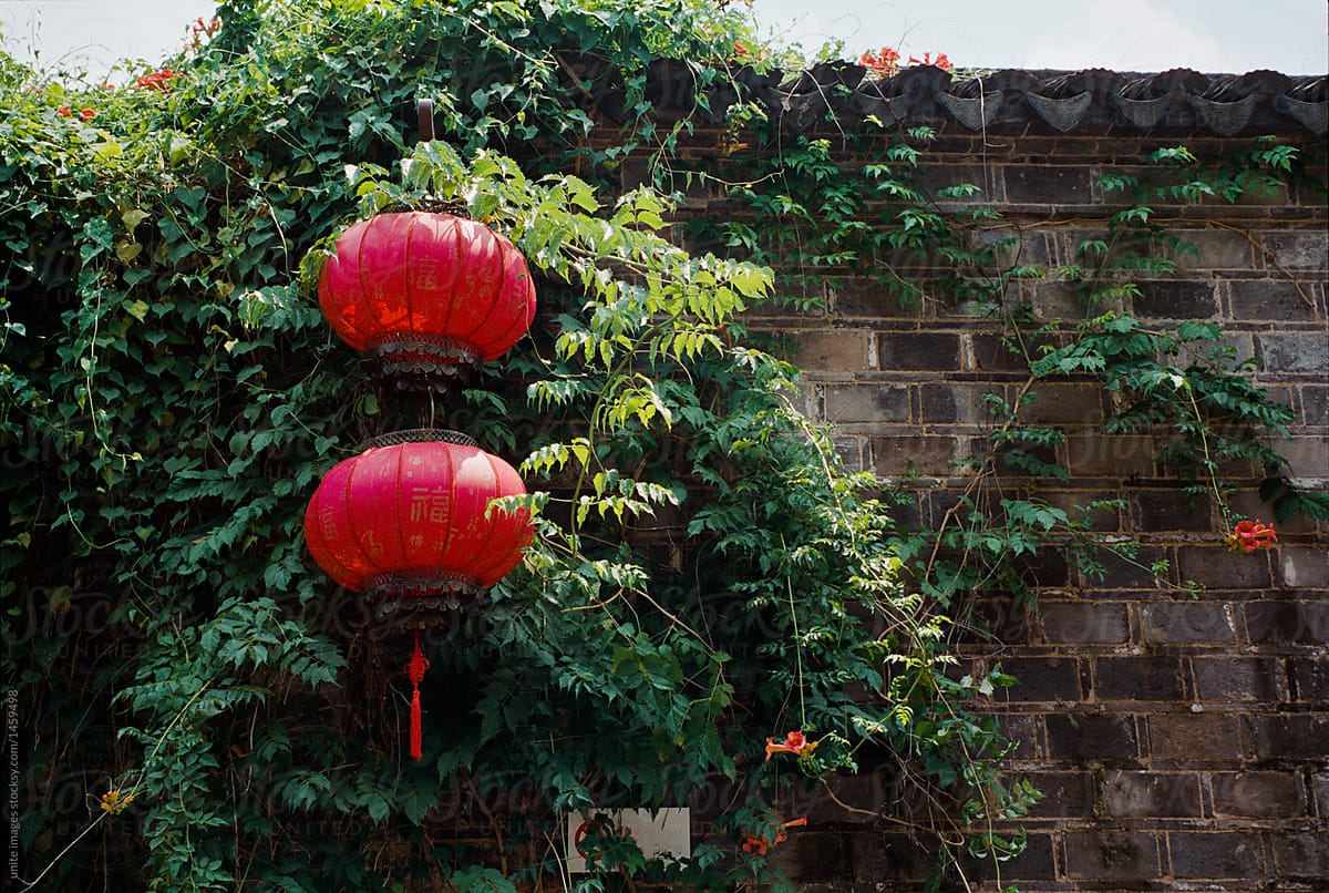 decorative red lanterns hanging on tiled roof