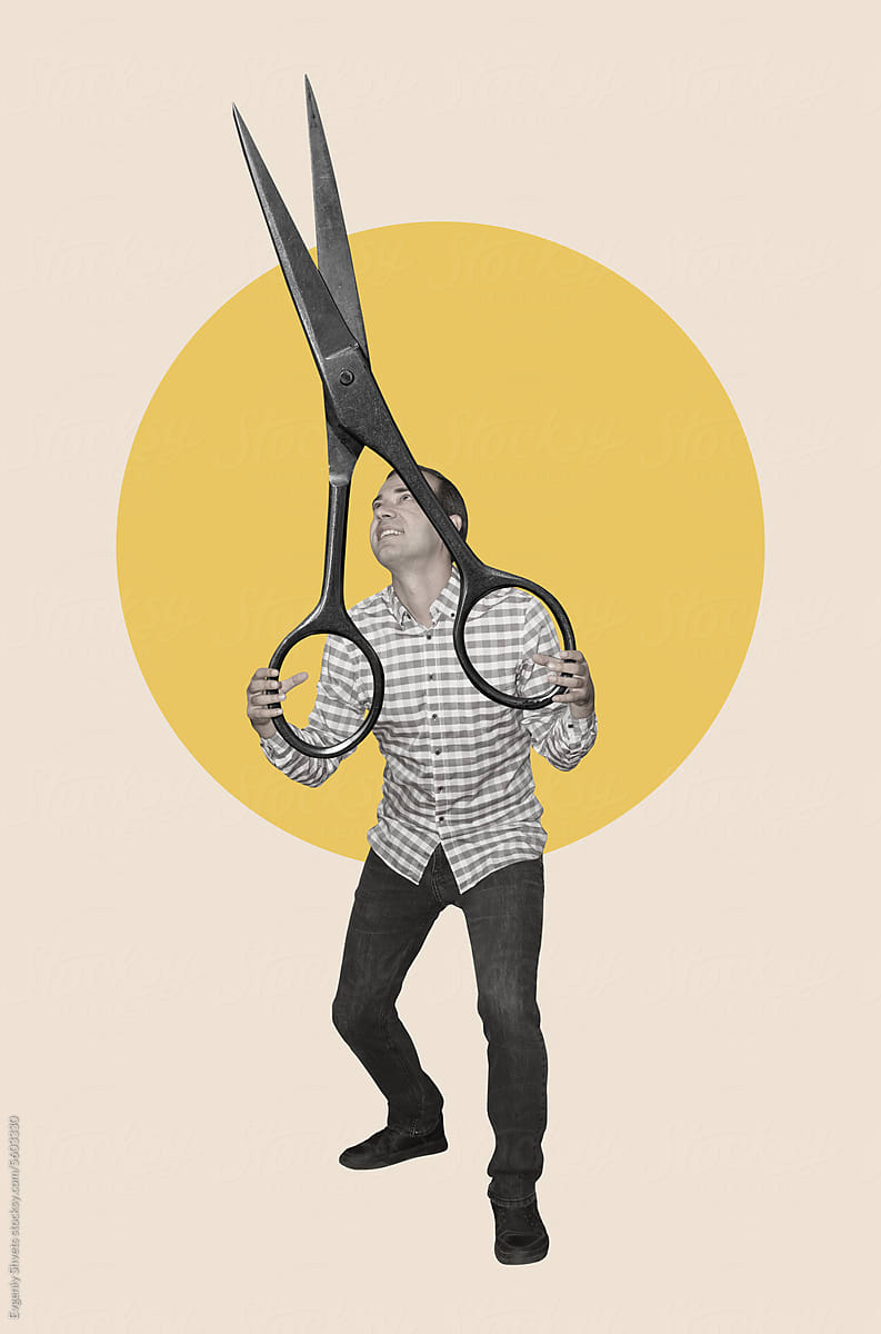 A Man Holding Giant Scissors by Stocksy Contributor Evgeniy
