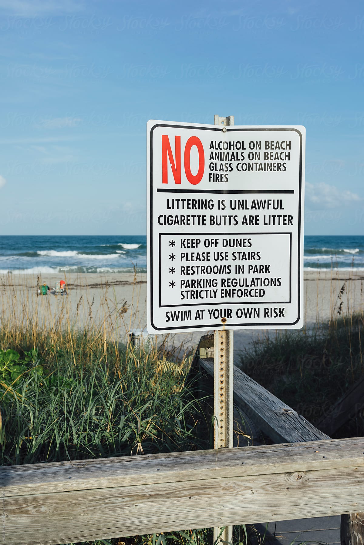 Warning sign with a long list of things you can't do at the beach