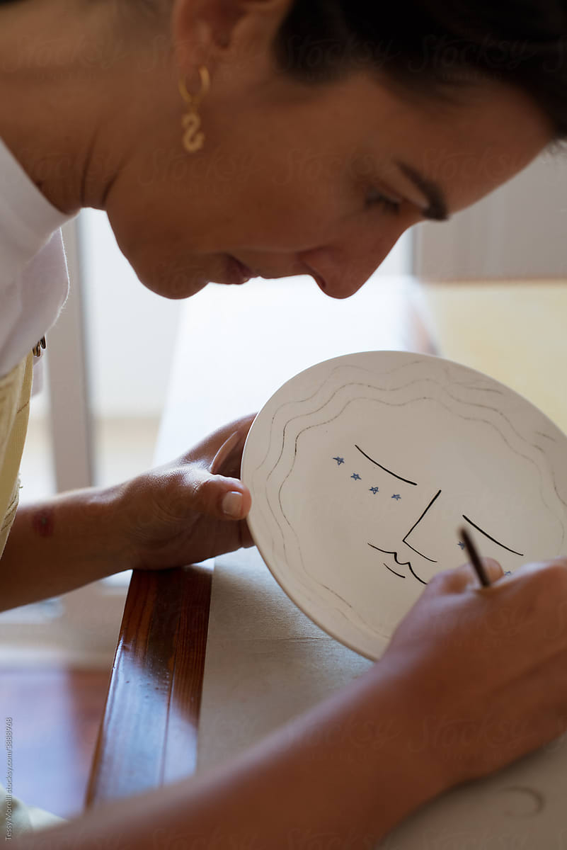 Woman drawing on a plate