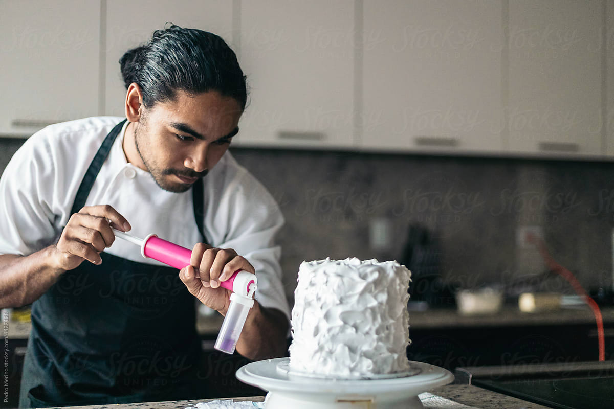 Pastry chef decorating a cake