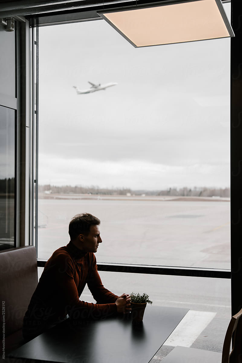 Young male sitting in cafe in airport