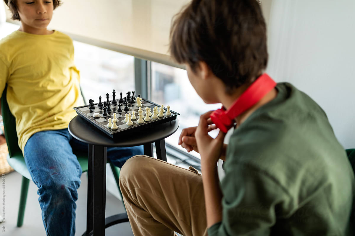 Kids playing chess in playroom