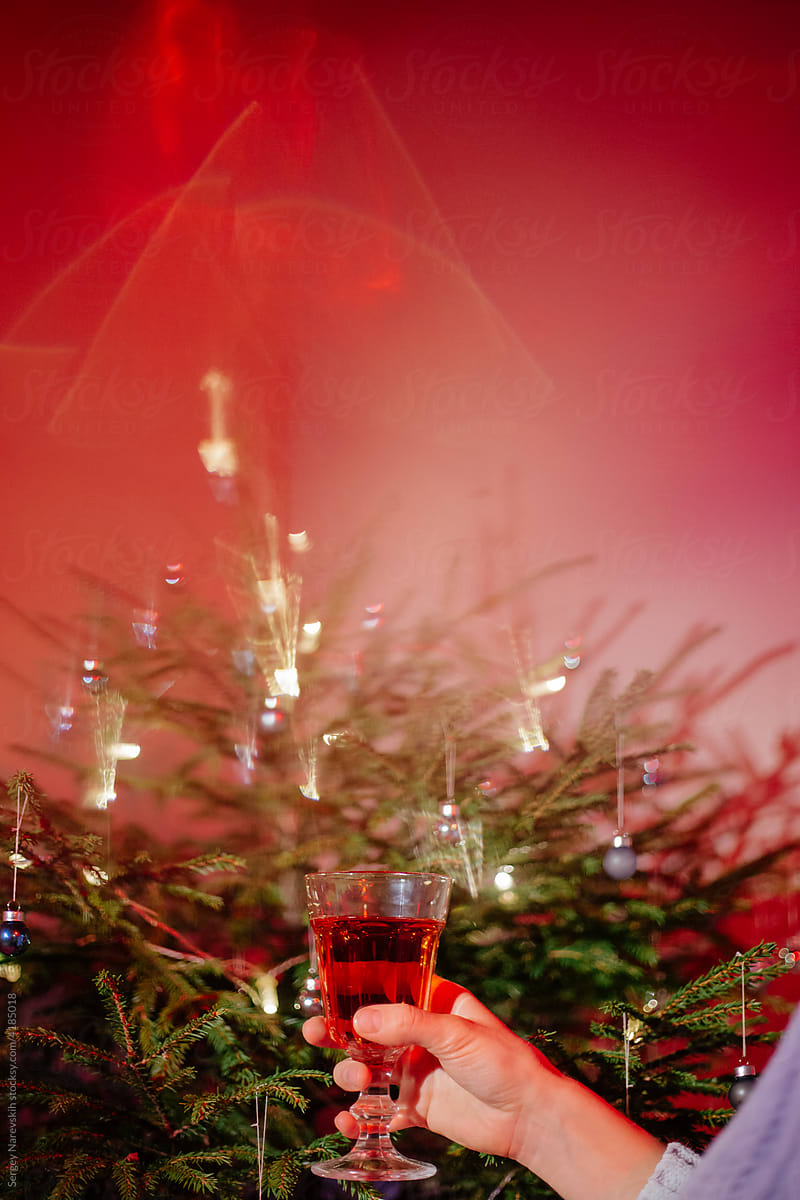 Woman holding champagne glass celebrating Christmas