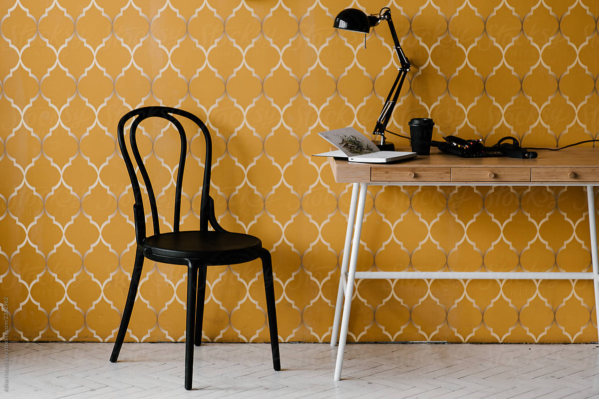 Chair and table near patterned wall