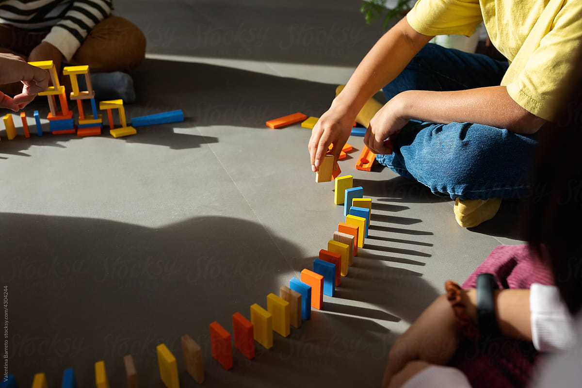 Detail of kids making circuit with dominoes