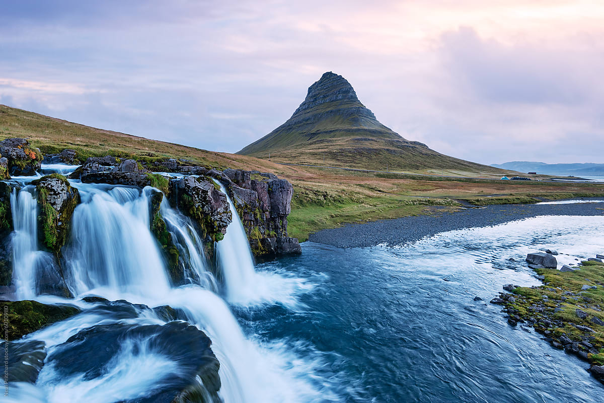 Kirkjufellsfoss Waterfall​ And Mountain At Sunrise