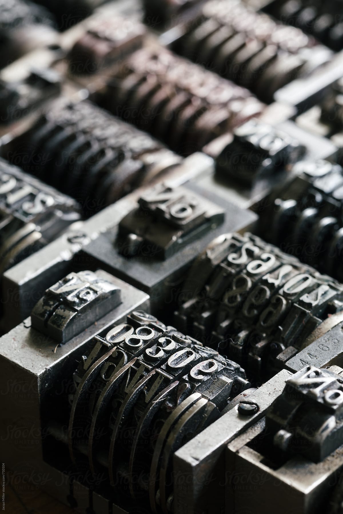 Macro of vintage metal numbering inserts for printer - vertical