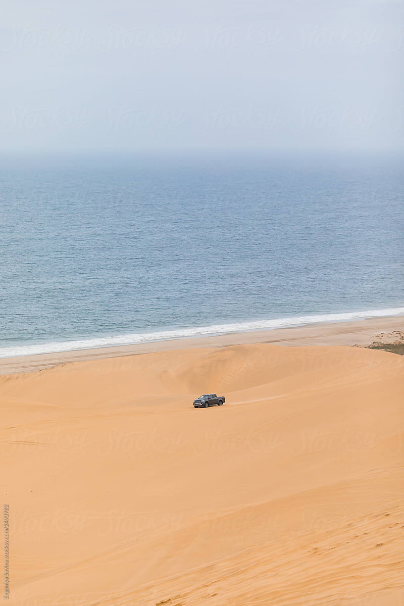 A car driving through the wild desert coast in Namibia