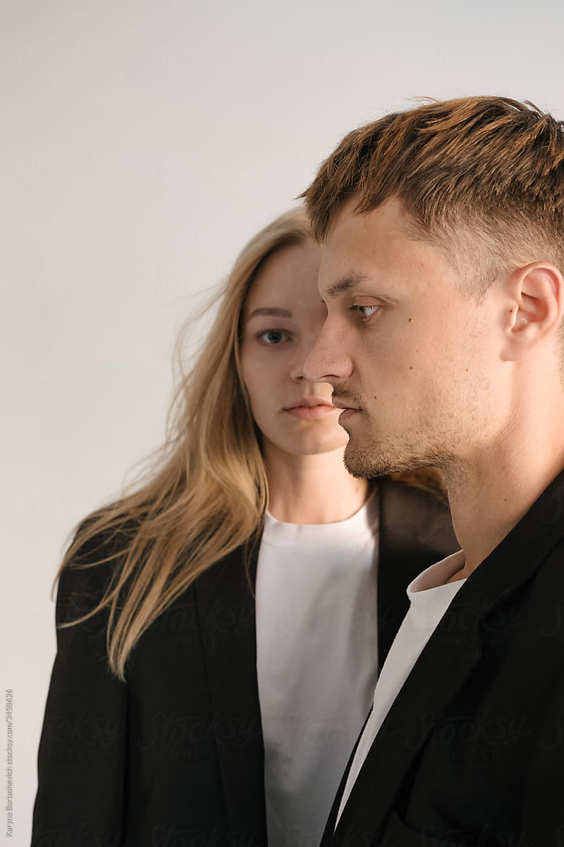 portrait of brother and sister in black jackets in a light studio