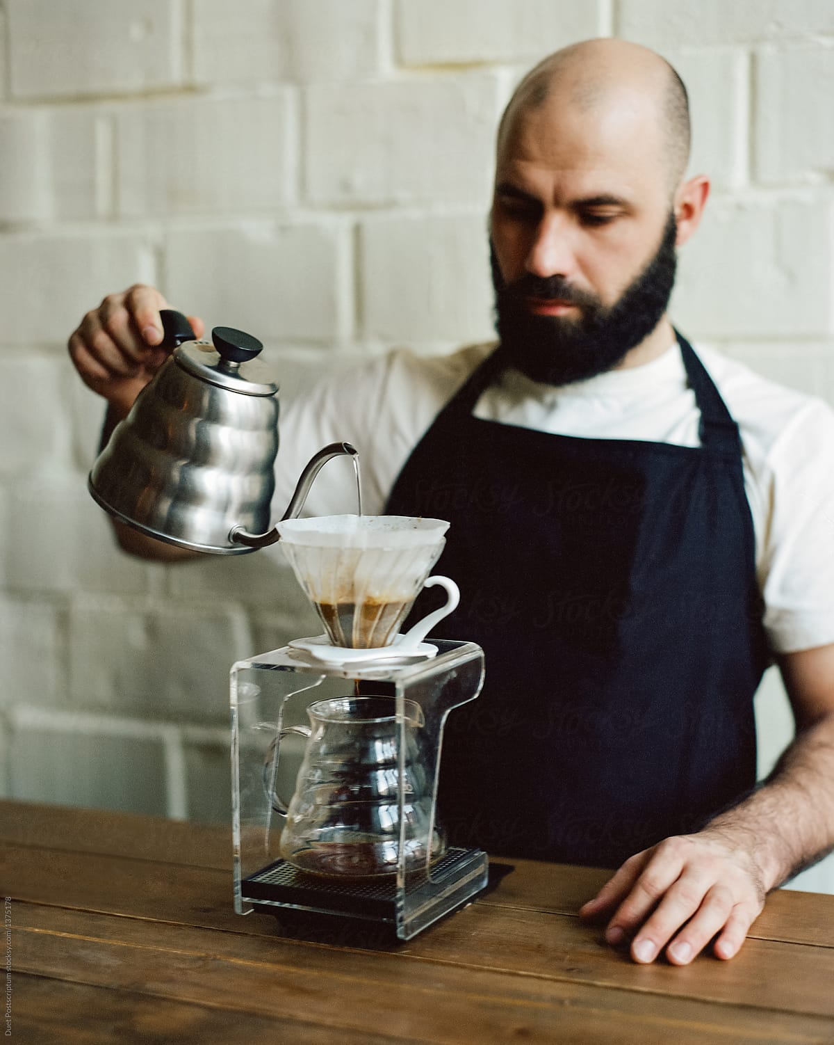 Barista pouring hot water in pour over coffee