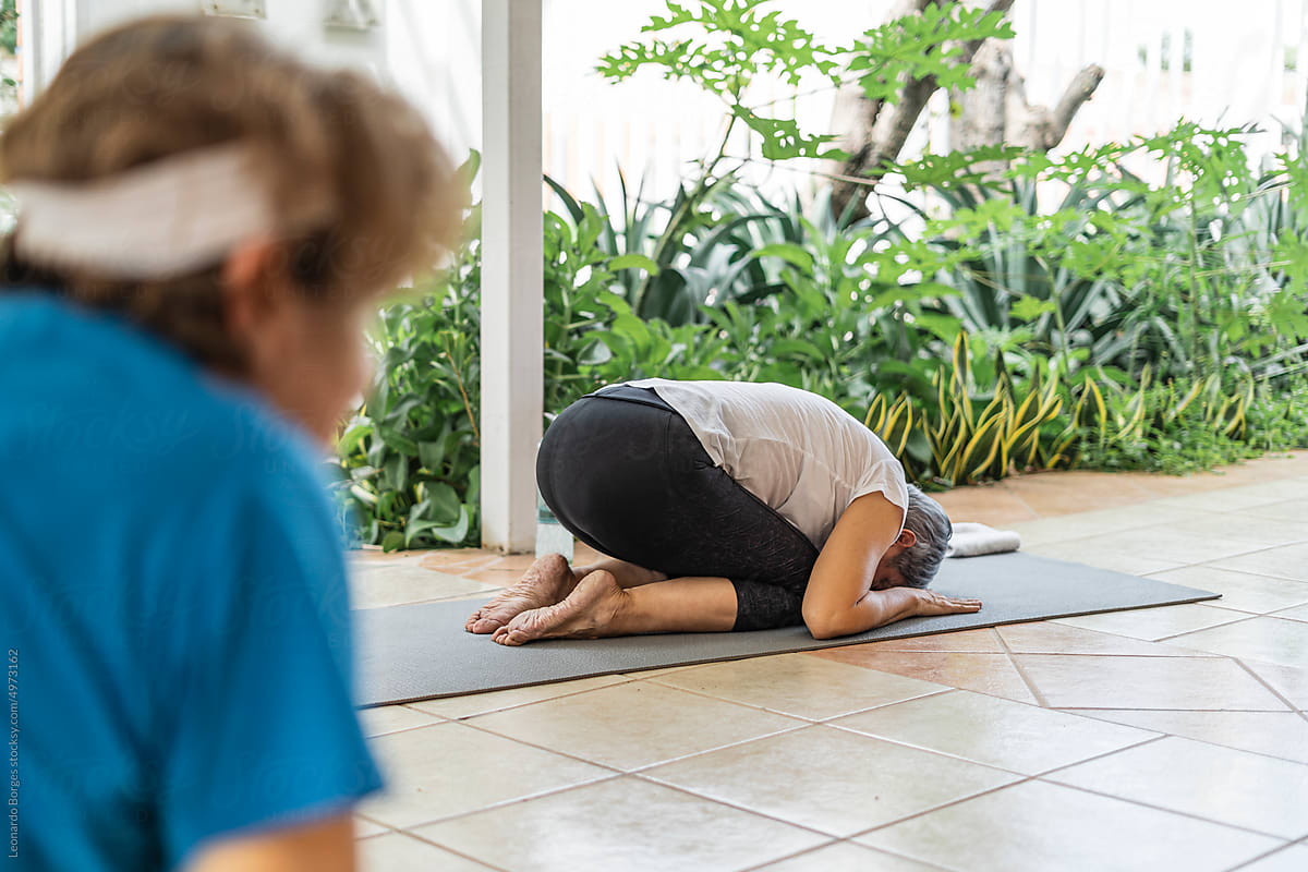 Older adult by performing the position of the yoga child