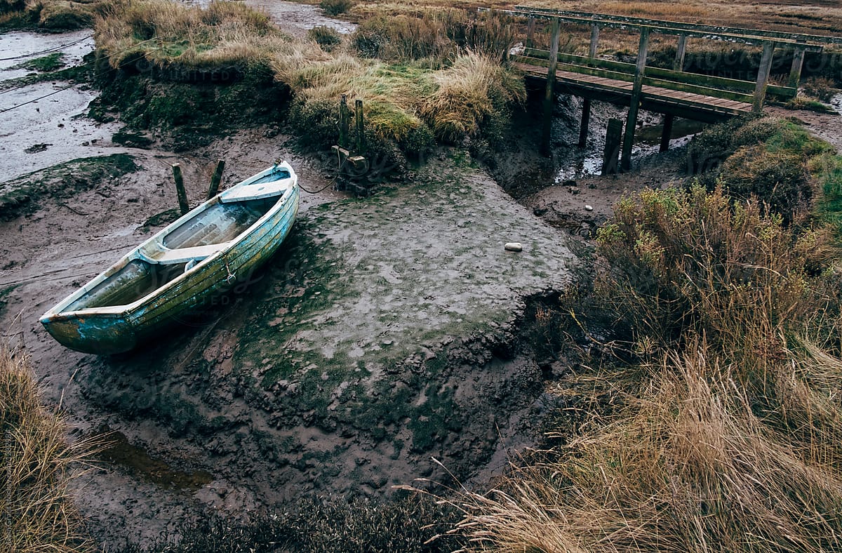 Old rowing boat on the mud flats at Morston Quay, Norfolk, UK.