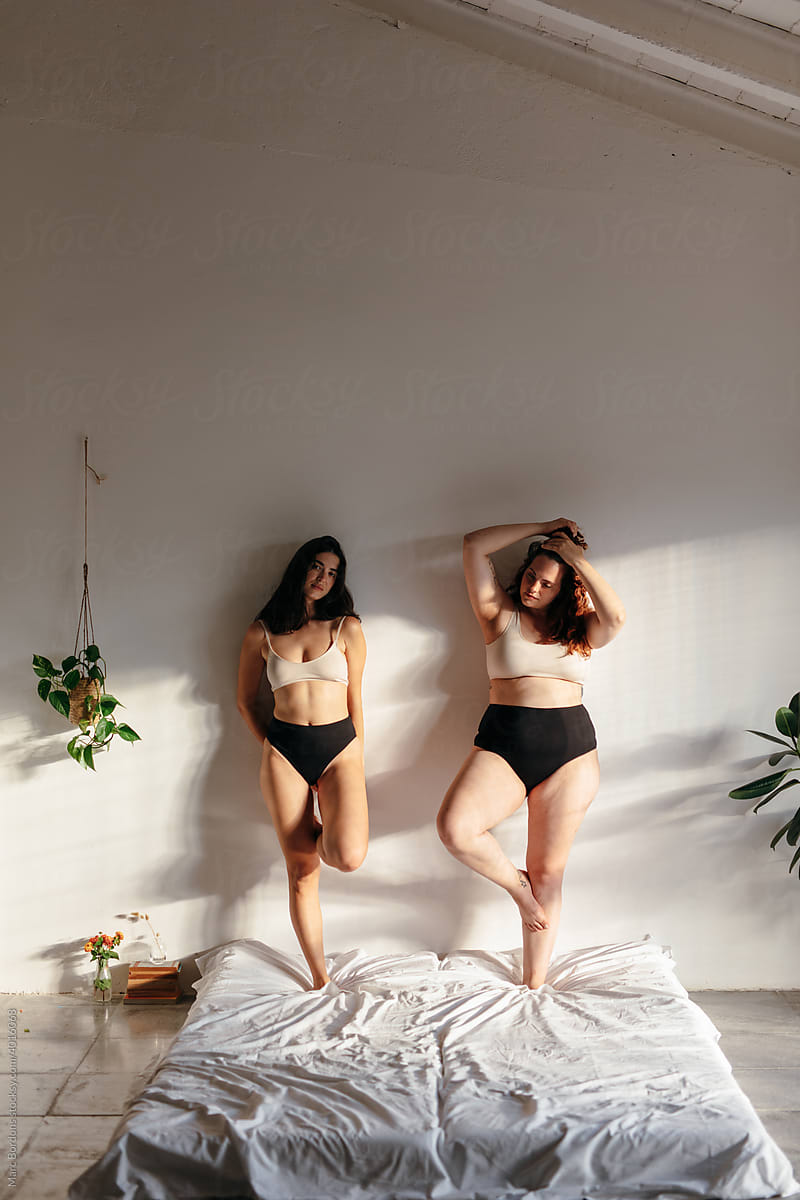 Two Friends Wearing Underwear Over A Bed by Stocksy Contributor Marc  Bordons - Stocksy