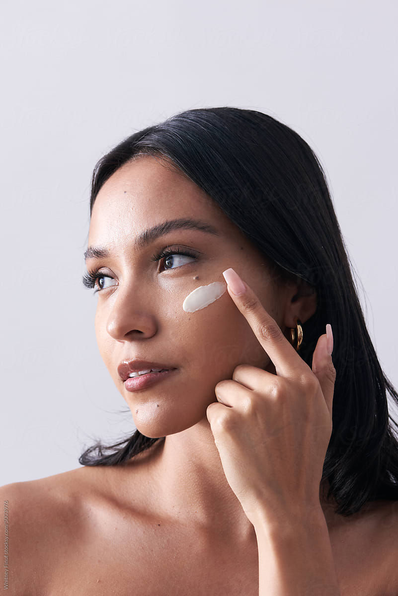 Latina Model Applies Luxurious Natural Organic Skincare to Cheek