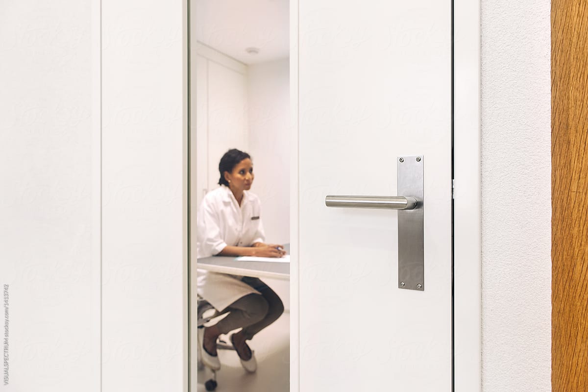 Female Hispanic Doctor Working Behind Closed Door