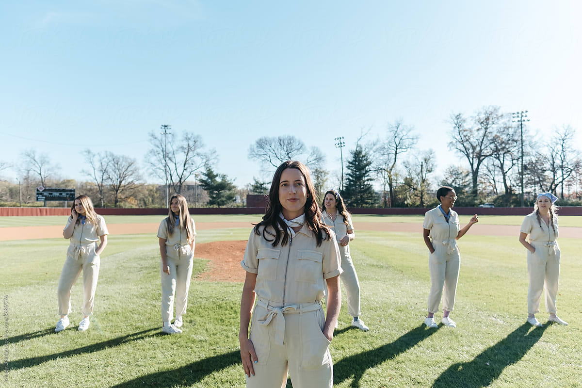 Young women stand in formation on baseball field