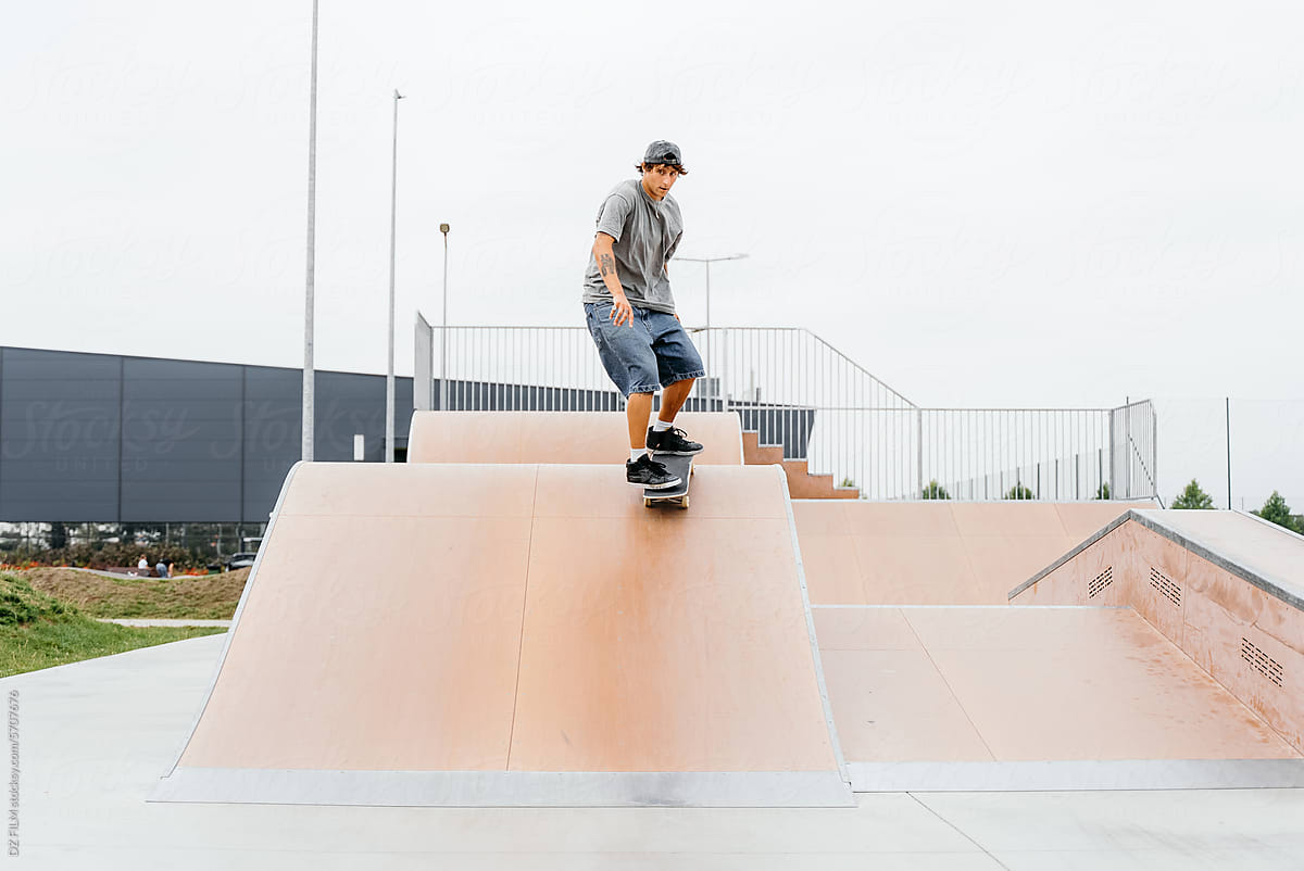A man rides a skateboard in a skate park