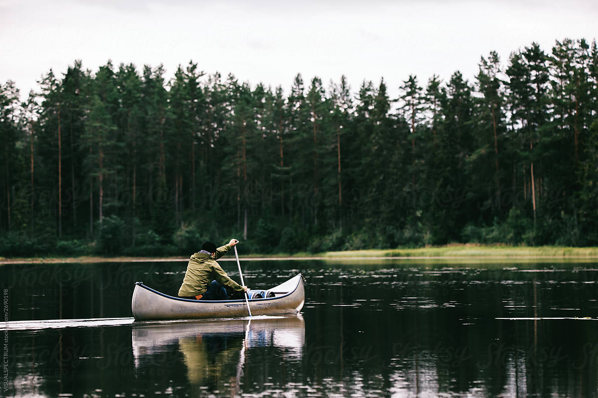 Man Paddling Canoe in Scandinavia