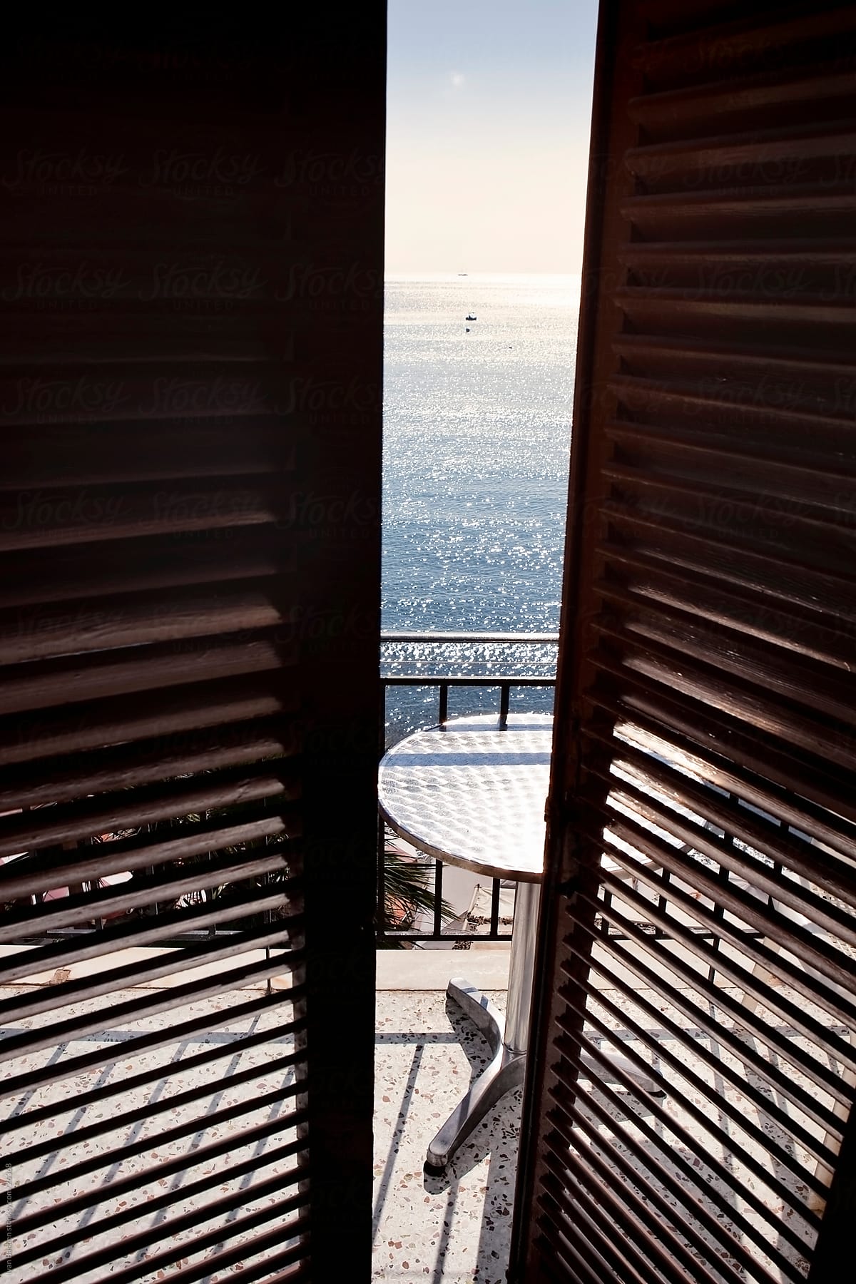 Open shutters on a hotel balcony in Greece