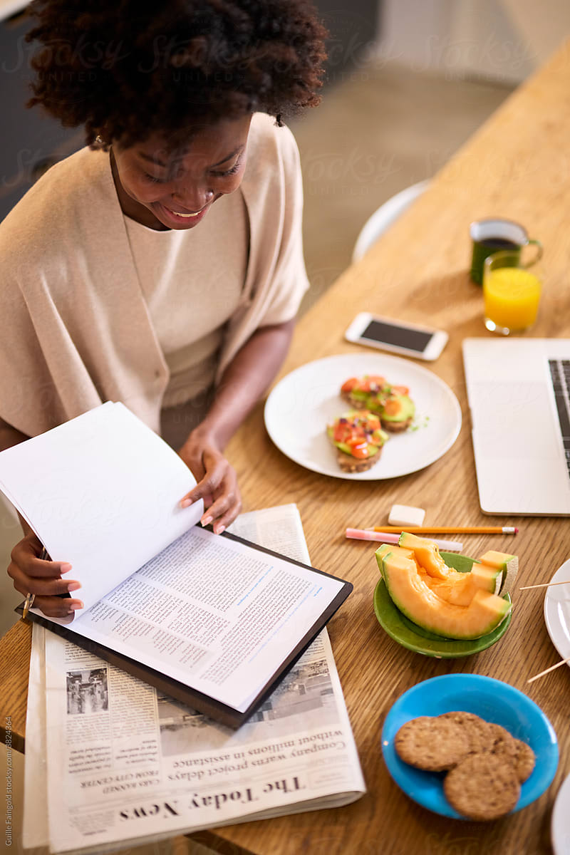 Black woman reading fresh information in morning.