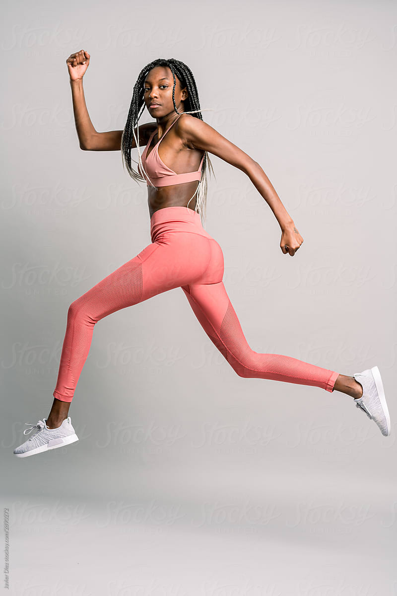 Slim black woman exercising and looking at camera