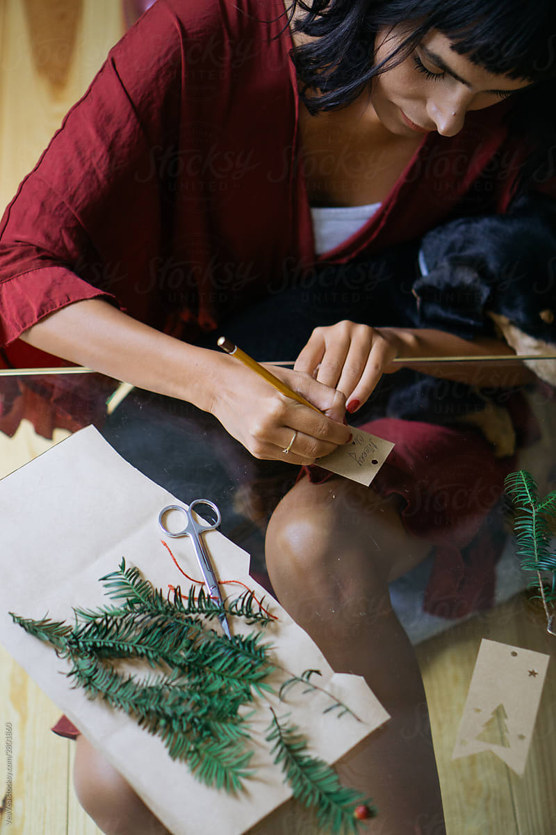 Brunette woman writing a Christmas card