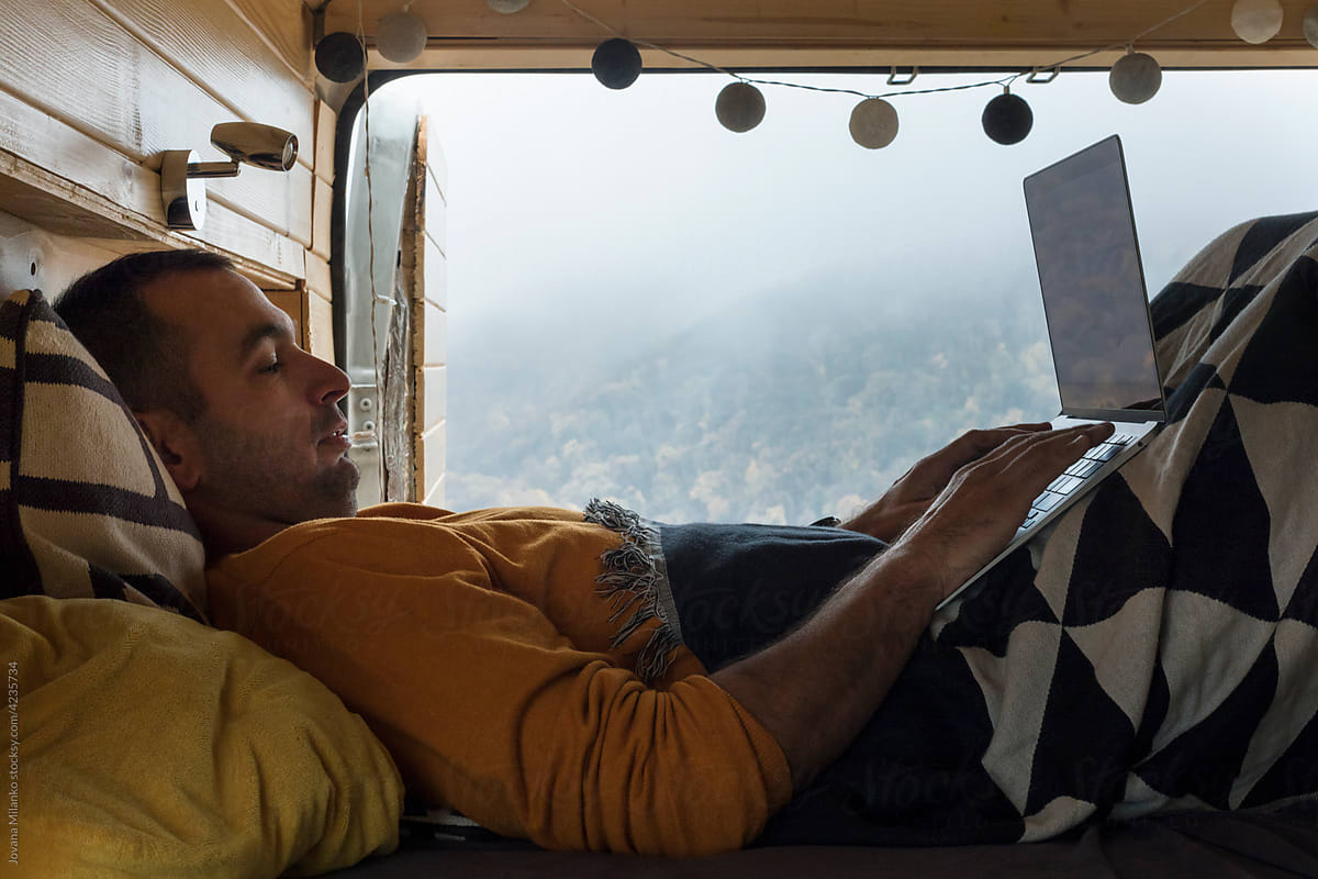 Man Working on Laptop in a Van