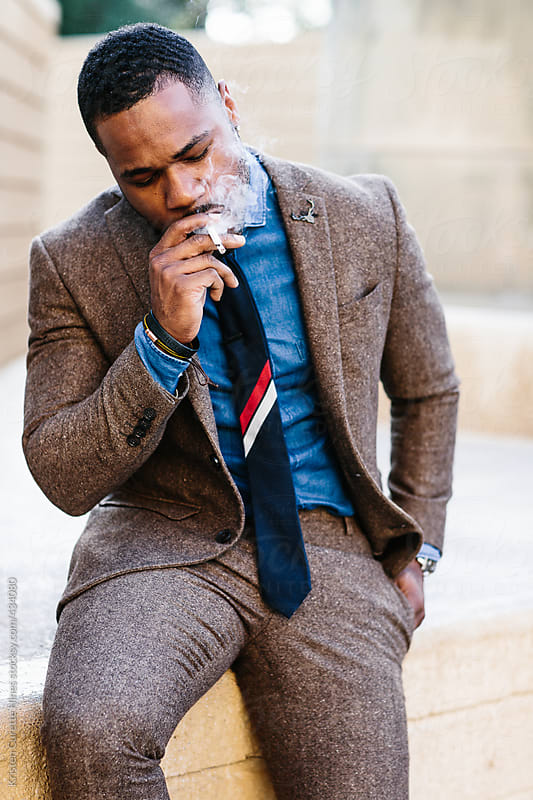 Guy In A Suit Smoking A Cigarette