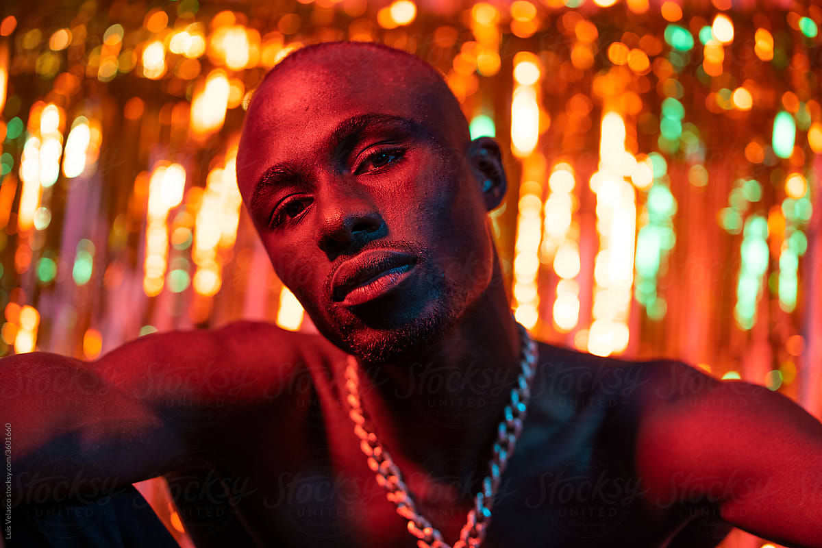 Portrait Of A Black Man With Necklace Under Red Light.