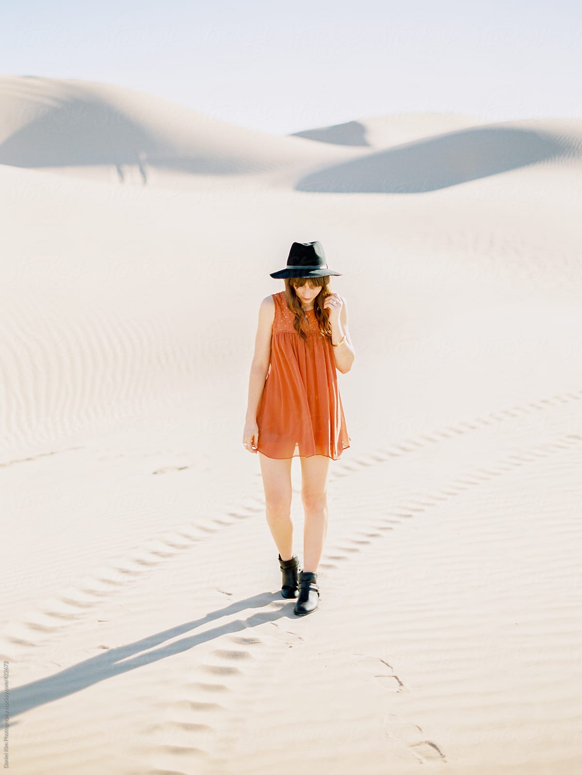 Young woman walking on sand dunes