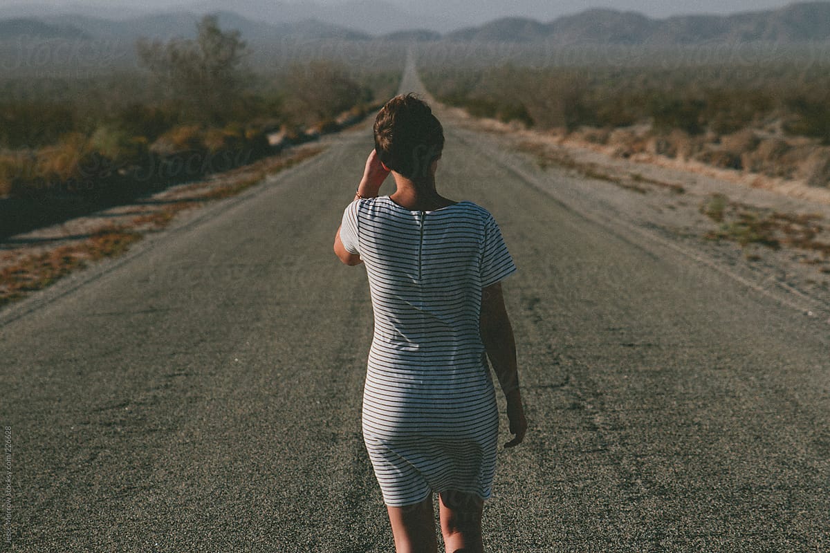 Young woman standing in the road