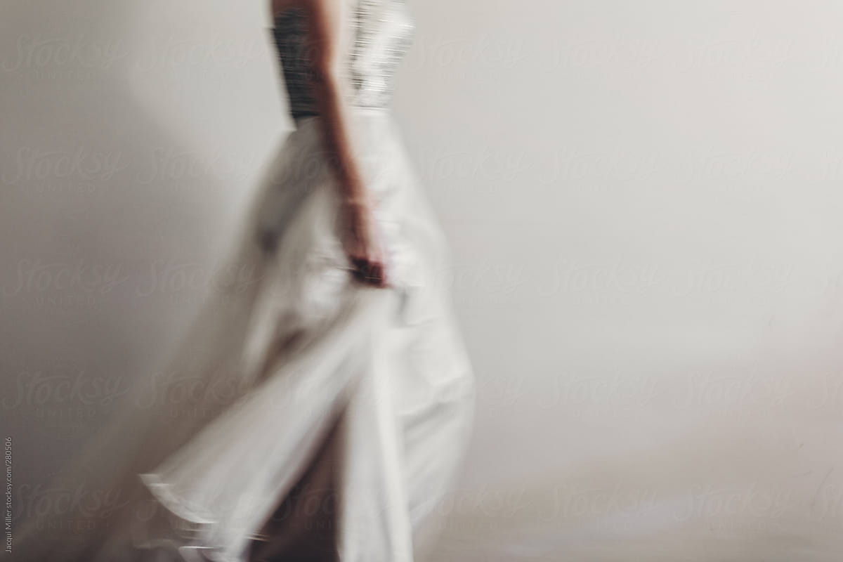Woman walking slowly in a long evening gown