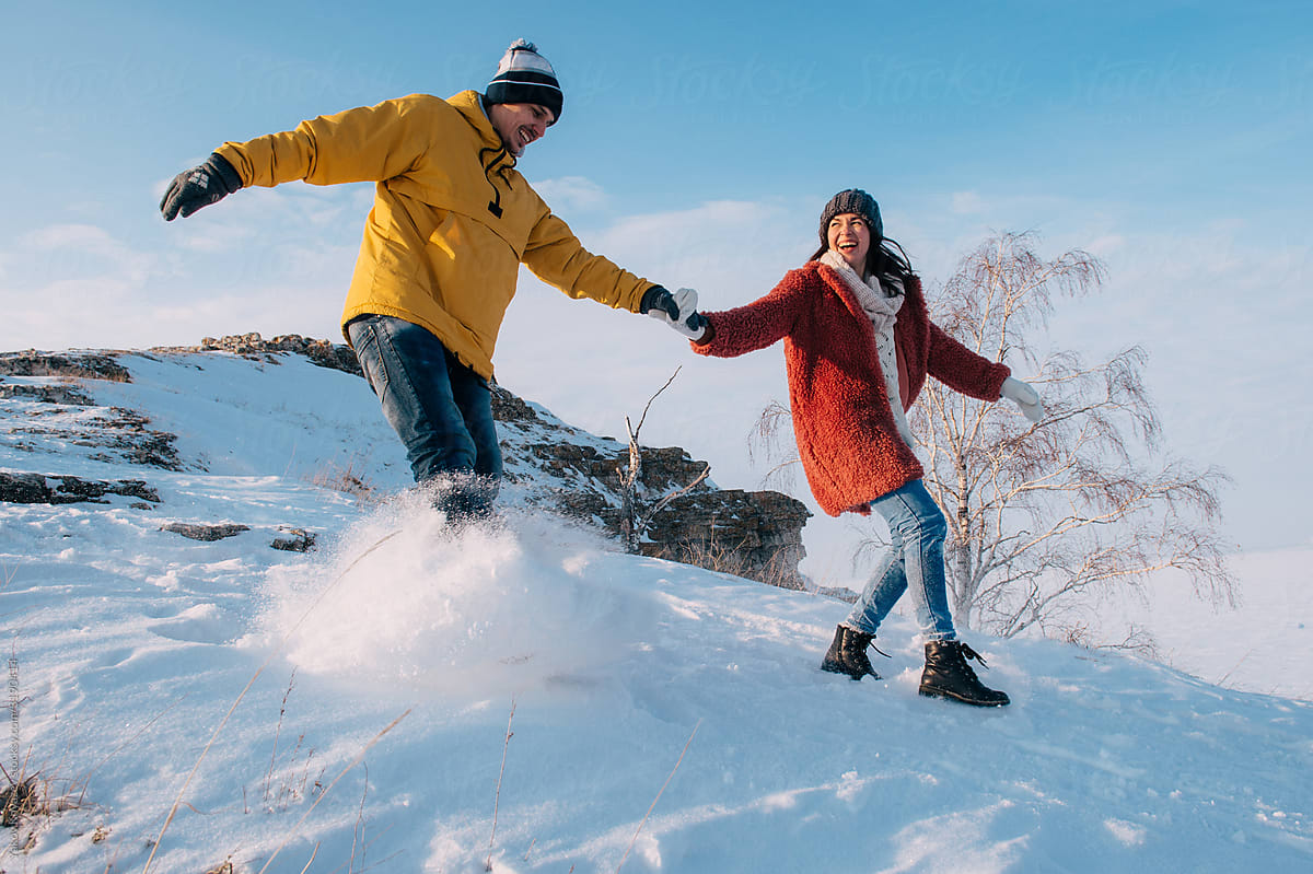 Winter love story. Young couple having fun in the mountains