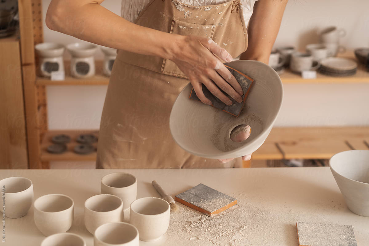 Anonymous Artisan Working On A Ceramic Objects With Sandpaper