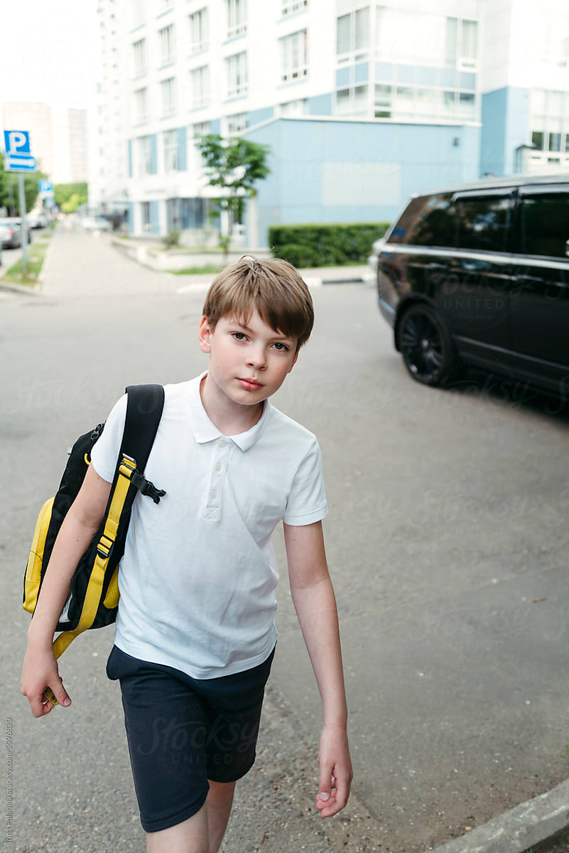 Boy with backpack goes to school.