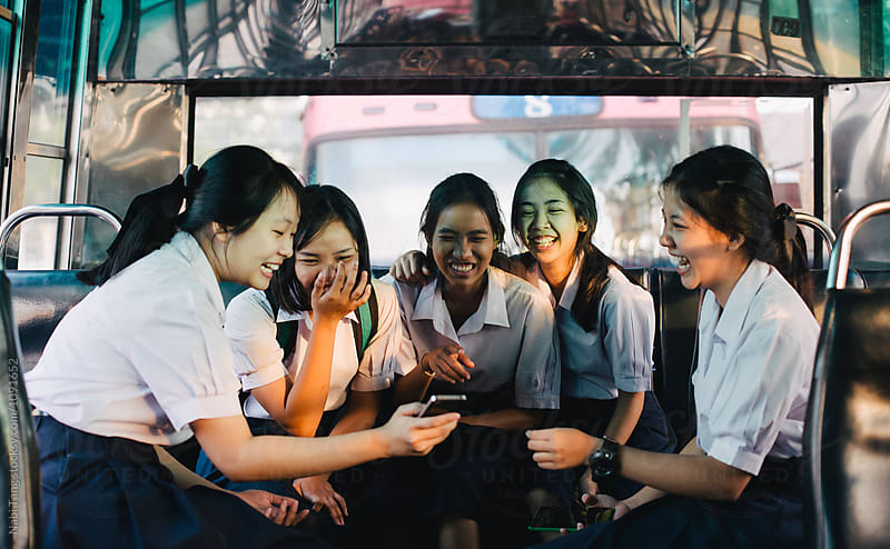 High school students in uniform on the bus in Bangkok