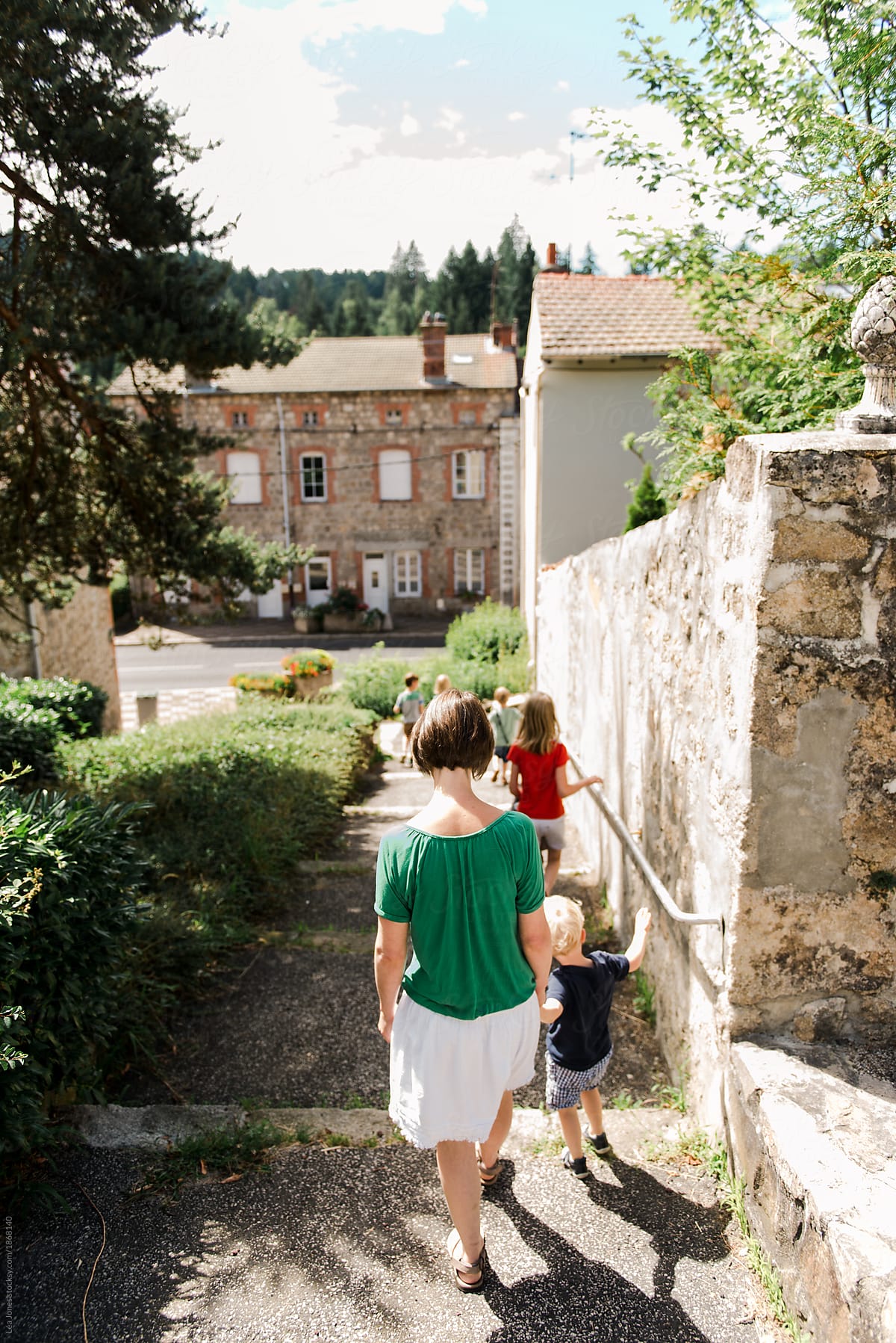 mother walking with children in French village