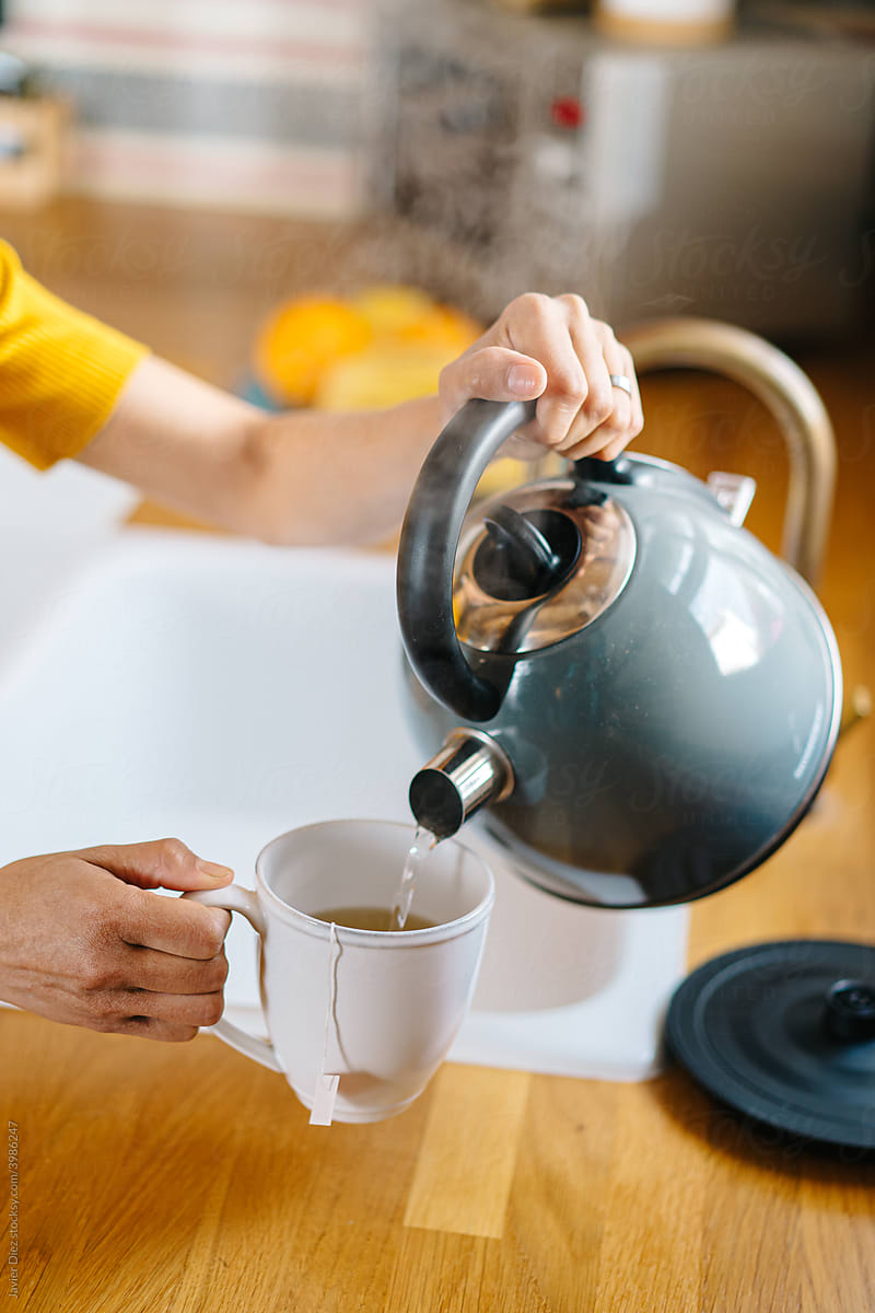 Woman preparing tea in morning