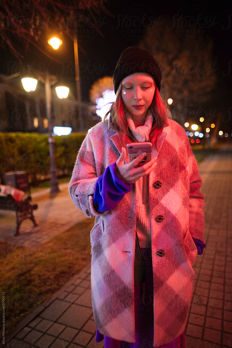 Modern Girl With Phone On The Street At Night