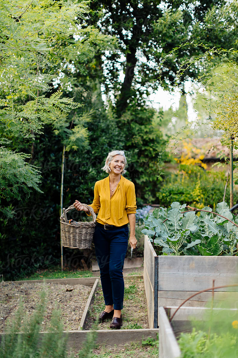 Cheerful woman in green garden