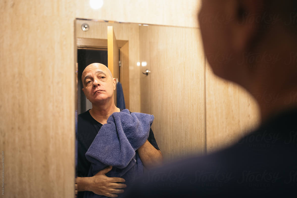 Man looking in the mirror after shaving