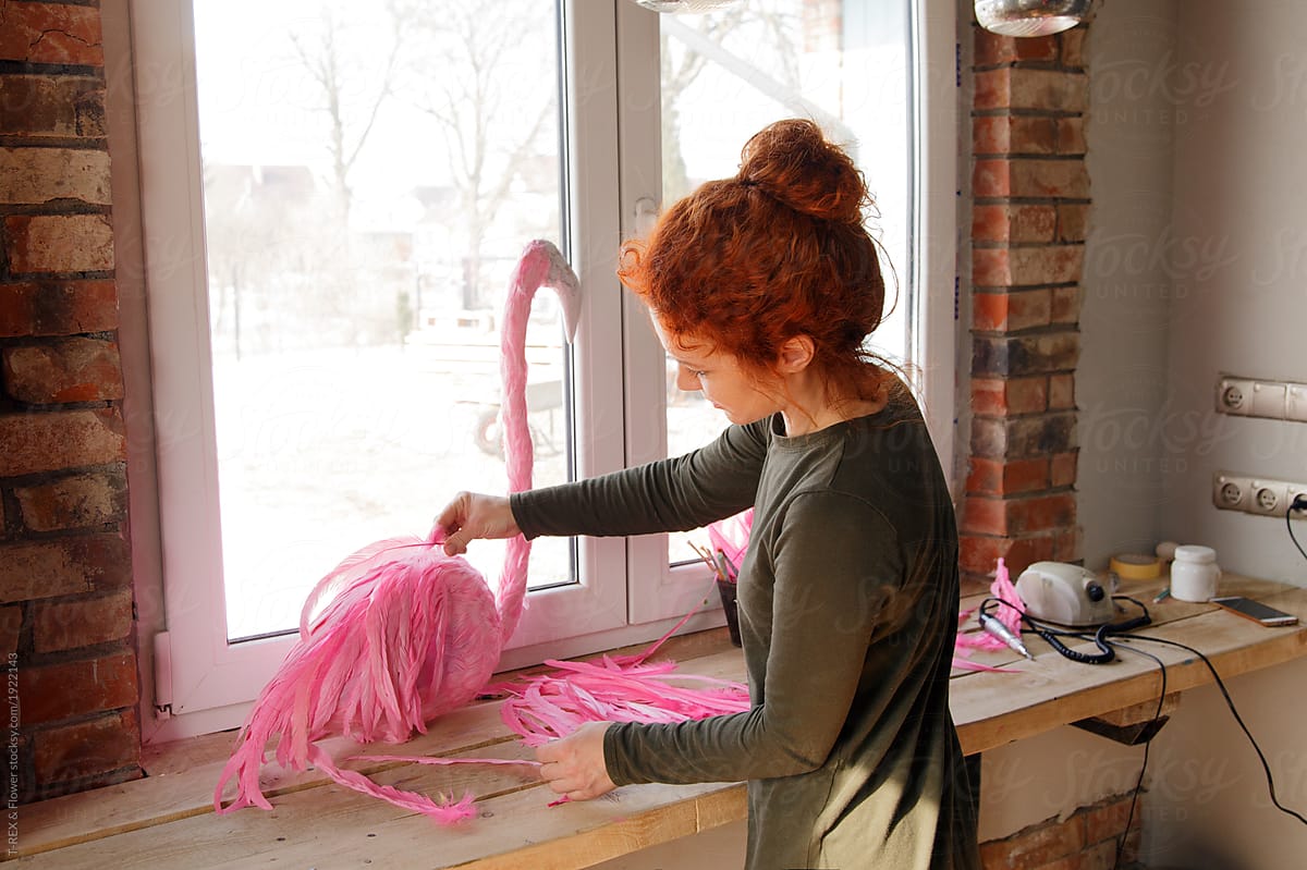 Woman working on flamingo in workshop