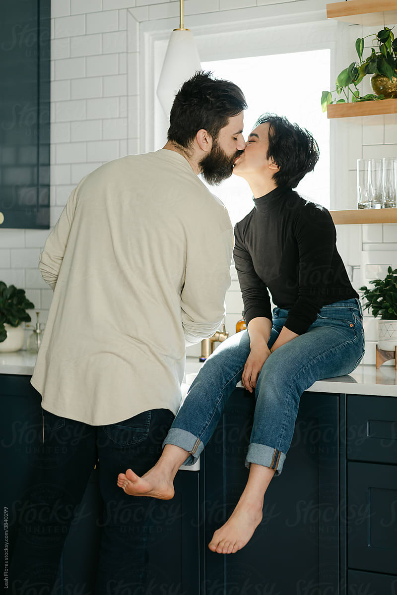 A Couple Shares a Kiss in the Kitchen