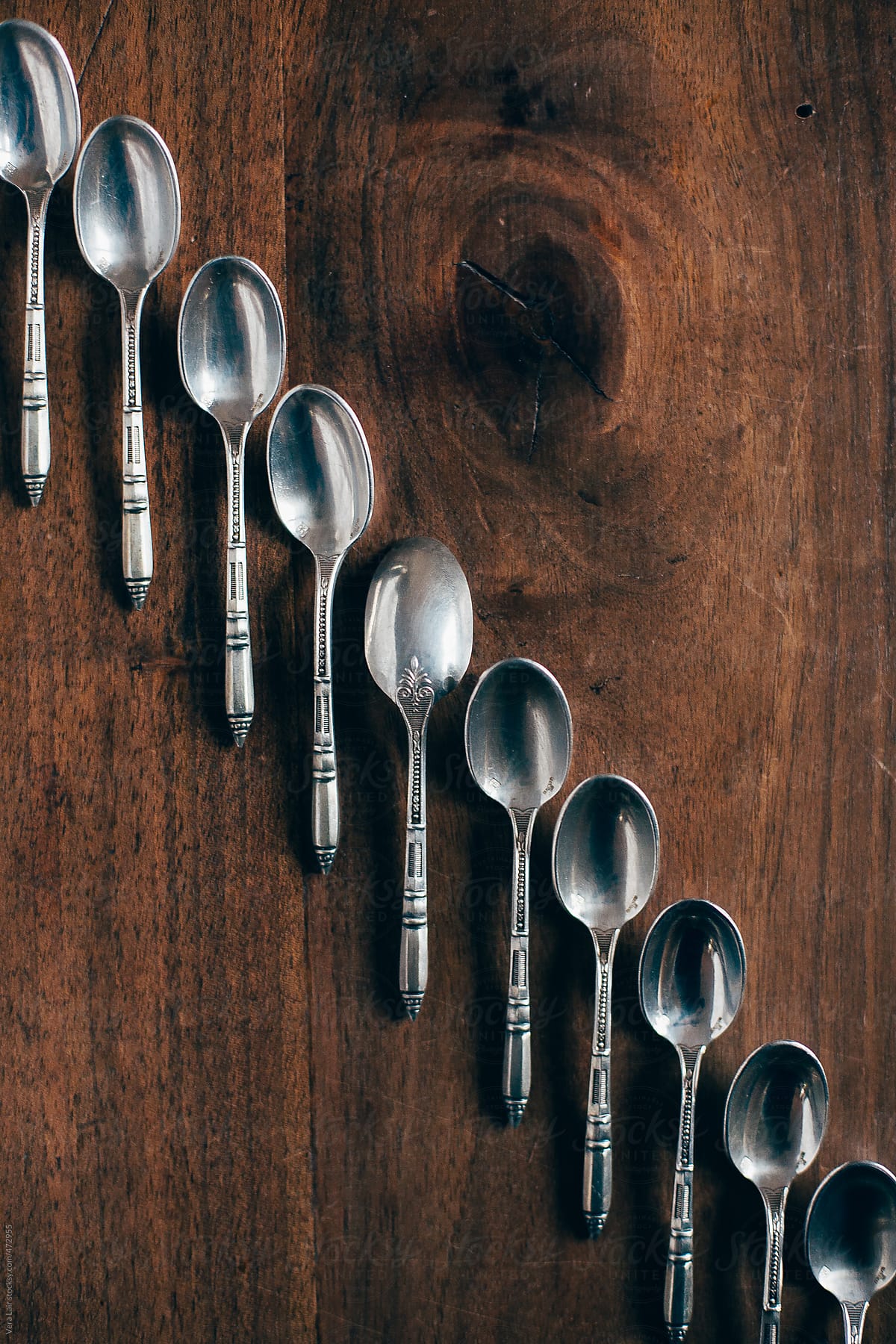 Line of small silver spoons