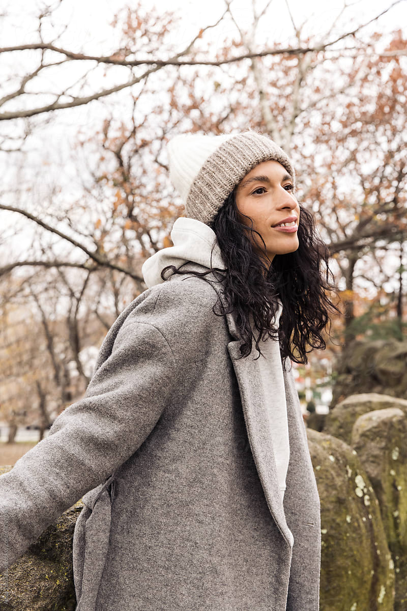 Model wearing wool coat and beanie outdoors
