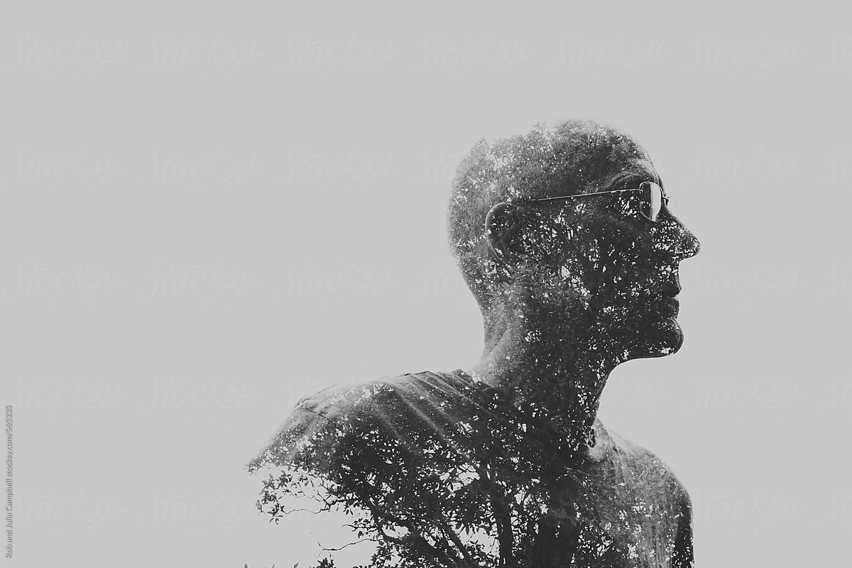Double exposure of older man and trees in black and white