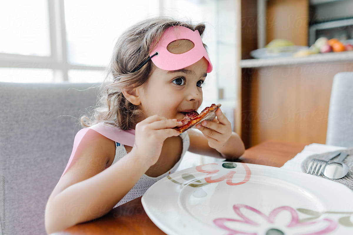 A girl eating pizza