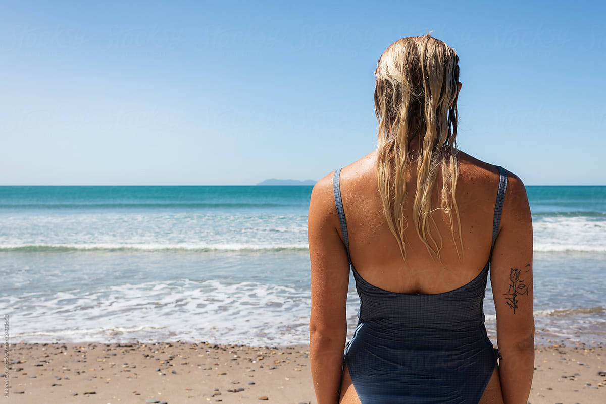 Unrecognizable Young Woman facing the Ocean